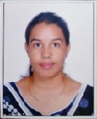 Portrait of Dr. Kapoor wearing traditional attire with academic books in background